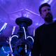 Director Adam Wingard stands on the very purple-lit set of Godzilla vs. Kong.
